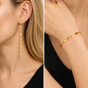 Detailed view of golden geometric triangle jewelry set with long earrings and bracelet