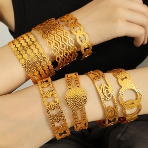 18K gold plated titanium steel bangles with textured evil eye and floral cutouts