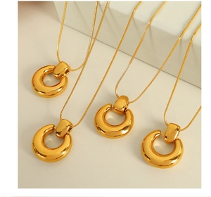 Detail of four chunky 18K gold plated hoop pendant necklaces on snake chains