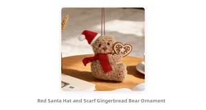 Detailed view of a plush Christmas teddy bear with a red hat and gingerbread heart