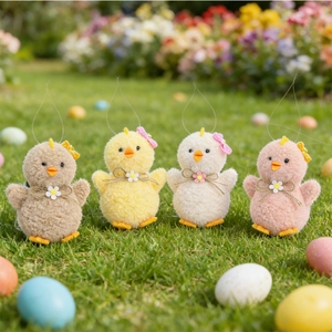 Detailed view of four colorful plush Easter chicks on green grass with decorative eggs