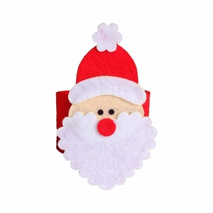 Detailed close-up of felt Santa Claus napkin ring with vibrant red and white fiber texture