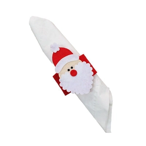 Detail of felt Santa Claus napkin ring set shown on white fabric napkin decoration