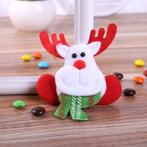 Christmas reindeer felt ornament with red nose and green plaid scarf on wood