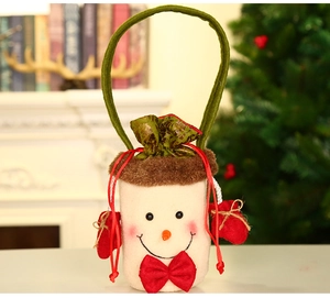 Detail van de pluchen sneeuwpop kerstcadeautas met rode strik en groen vilten handvat