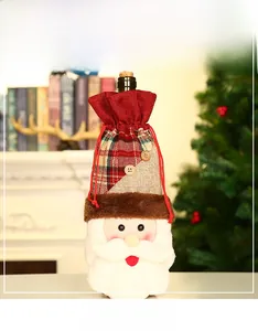 Detail of Santa wine bottle cover with red plaid fabric and white plush beard decor