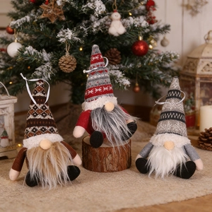 Close-up of three Christmas gnomes with knitted hats and long white faux fur beards
