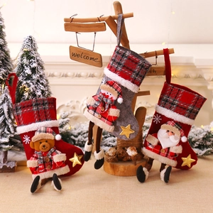 Three Christmas stockings with 3D Santa, Snowman and Bear dolls on red plaid fabric