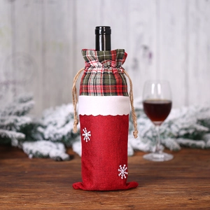 Christmas burlap wine bottle cover with red green plaid and white snowflake motifs