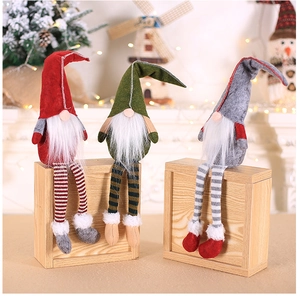 Three Christmas long-legged gnomes with striped legs on rustic wooden display