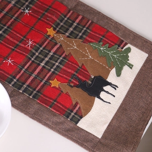 Christmas table runner with red plaid patterns, embroidered reindeer and pine trees