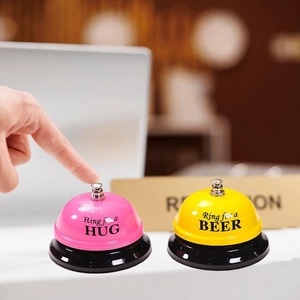Detail of pink and yellow metal service bells with Ring for a Hug and Beer text
