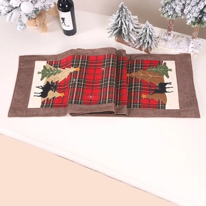 Christmas table runner with red plaid patterns and embroidered reindeer on linen fabric