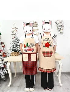 Close-up of linen Christmas aprons with red truck and festive floral print patterns