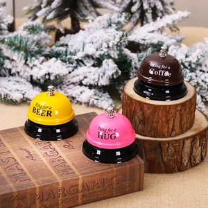 Three colorful metal service bells for beer, hugs, and coffee on a festive winter background
