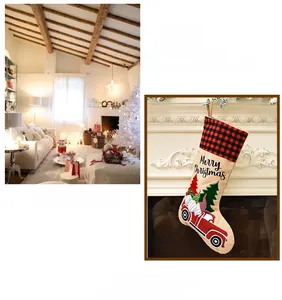 Detail of burlap Christmas stocking with red plaid cuff and festive truck tree embroidery