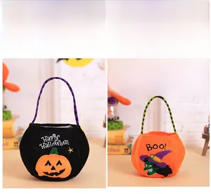 Detail of Halloween felt gift bags with pumpkin and ghost patterns and striped handles
