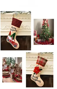 Scene display of burlap Christmas stockings with Santa and poinsettia decorations