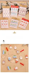 Detail of hand-painted wooden Christmas clips featuring Santa and snowman patterns