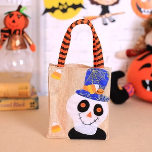 Halloween burlap candy bag with skull design and orange striped handle for party props