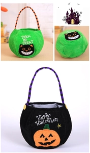 Detail of embroidered Halloween candy bags featuring a black cat and pumpkin with strip handles