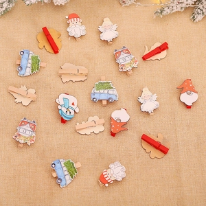 Set of Christmas wooden clips featuring Santa, Snowman and Angel on a rustic burlap background