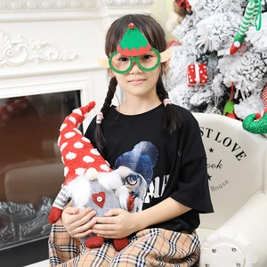 Christmas party prop set featuring gnome plush and glitter elf ear glasses for kids