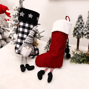 Christmas gnome stockings with plaid patterns and hanging fireplace decor for holiday gifts
