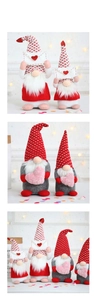 Macro view of Valentine's gnome dolls with knitted hats holding hearts and envelopes