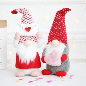 Pair of Valentine's Day gnomes with heart patterns and soft fiber beards on light background