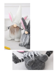 Close-up detail of Easter gnome plush with rabbit ears and black white striped arms