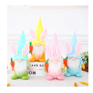 Detail of four Easter Gnomes with rabbit ears holding carrots on white decorative books