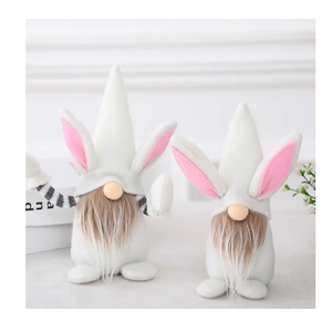 Close-up of Easter gnome plush toys with pink rabbit ears and fluffy brown beards