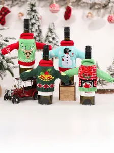 Detail of Christmas knitted wine bottle covers with reindeer, snowman, and bell patterns