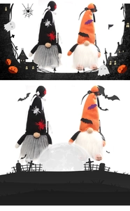 Detail of Halloween gnome plush dolls with bat and spider hat patterns on spooky background