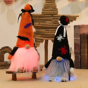 Halloween glowing faceless gnome dolls with bats and spider hats on wooden stars background