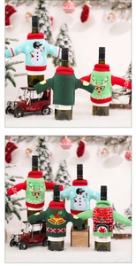 Detail view of knitted Christmas wine bottle covers with reindeer and snowman embroidery