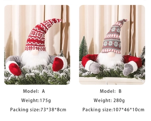 Detail of knitted Christmas tree gnome topper with long white beard and festive red hat