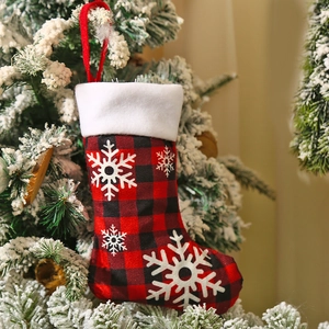 Large red and black buffalo plaid Christmas stocking with white snowflake and plush trim