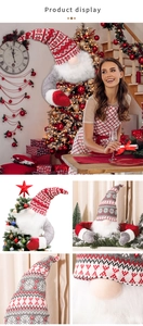 Detail showing the knitted Christmas gnome with long bendable arms hugging a pine tree