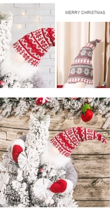 Close-up of knit Christmas forest gnome with snowflake hat on a festive tree topper