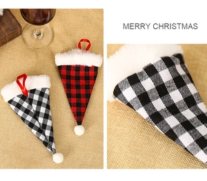 Close-up of red and white plaid Christmas mini hats with plush trim and hanging ribbons