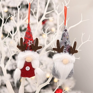 Christmas gnome ornaments with snowflake hats and antlers hanging on white branches
