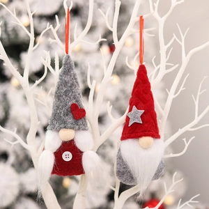 Set of two Christmas gnomes with felt hats and fuzzy beards hanging on festive white branches