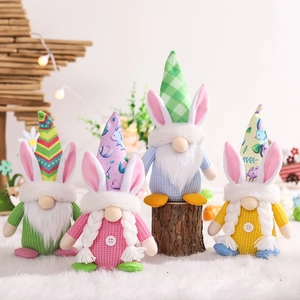 Set of four colorful Easter gnome plush dolls with bunny ears on a soft white rug