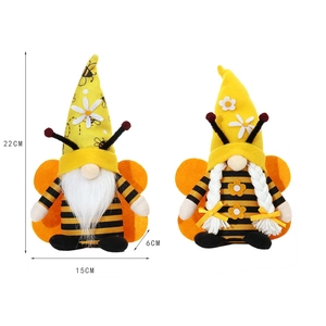Macro shot showing dimensions of two bee gnomes with yellow hats and striped wings