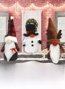 Detailed view of three Christmas gnomes including snowman and reindeer plush decor