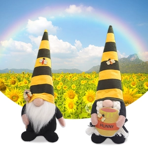 Pair of bumblebee gnome plush toys holding honey pot and dipper on sunflower background
