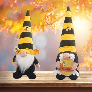 Set of two yellow and black striped bee festival gnomes with honey jar and honey dipper