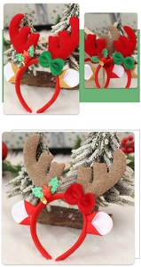 Detail of Christmas reindeer antler headband with festive bows and glittery stars